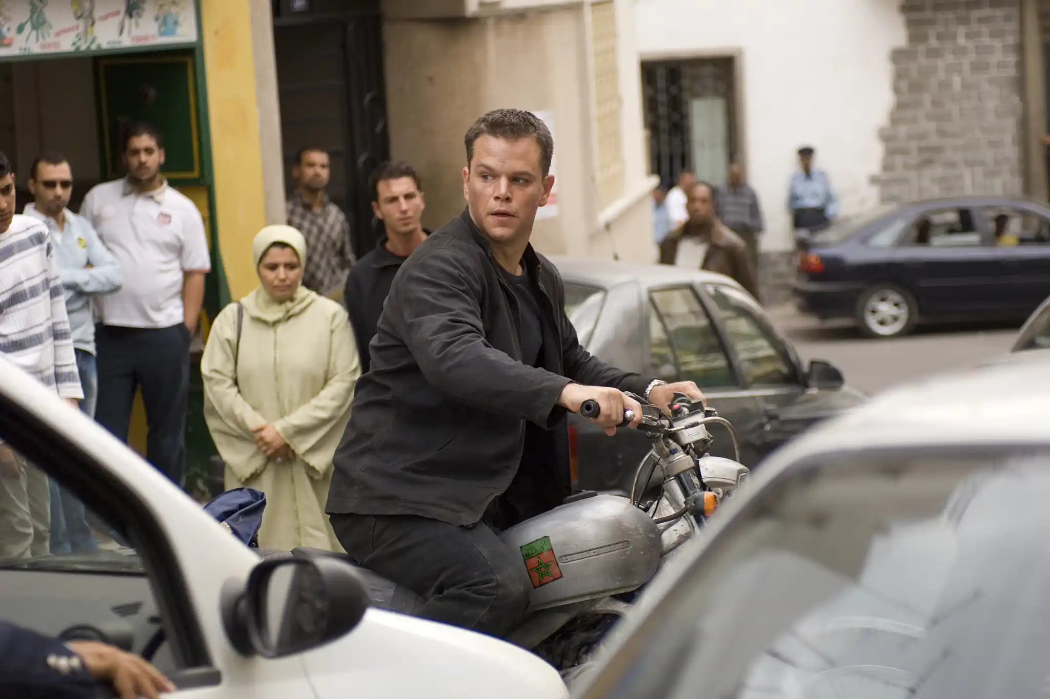 Jason Bourne (Matt Damon) rides his motorcycle in Tangier, Morocco.