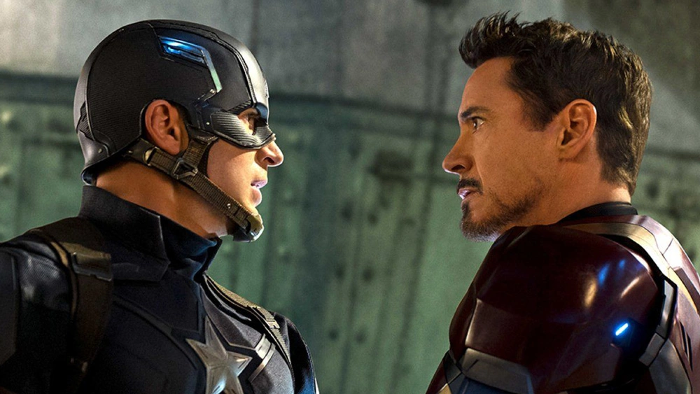 Captain America and Iron Man look fiercely into each other's eyes.