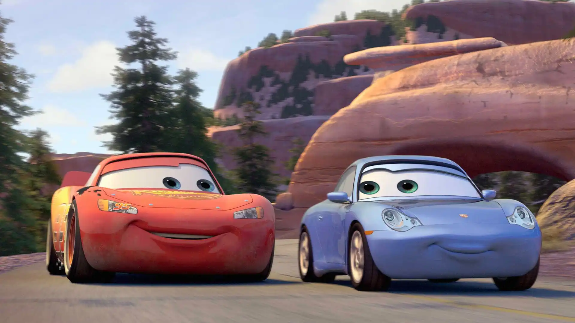 Two animated cars fall in love on a scenic road.