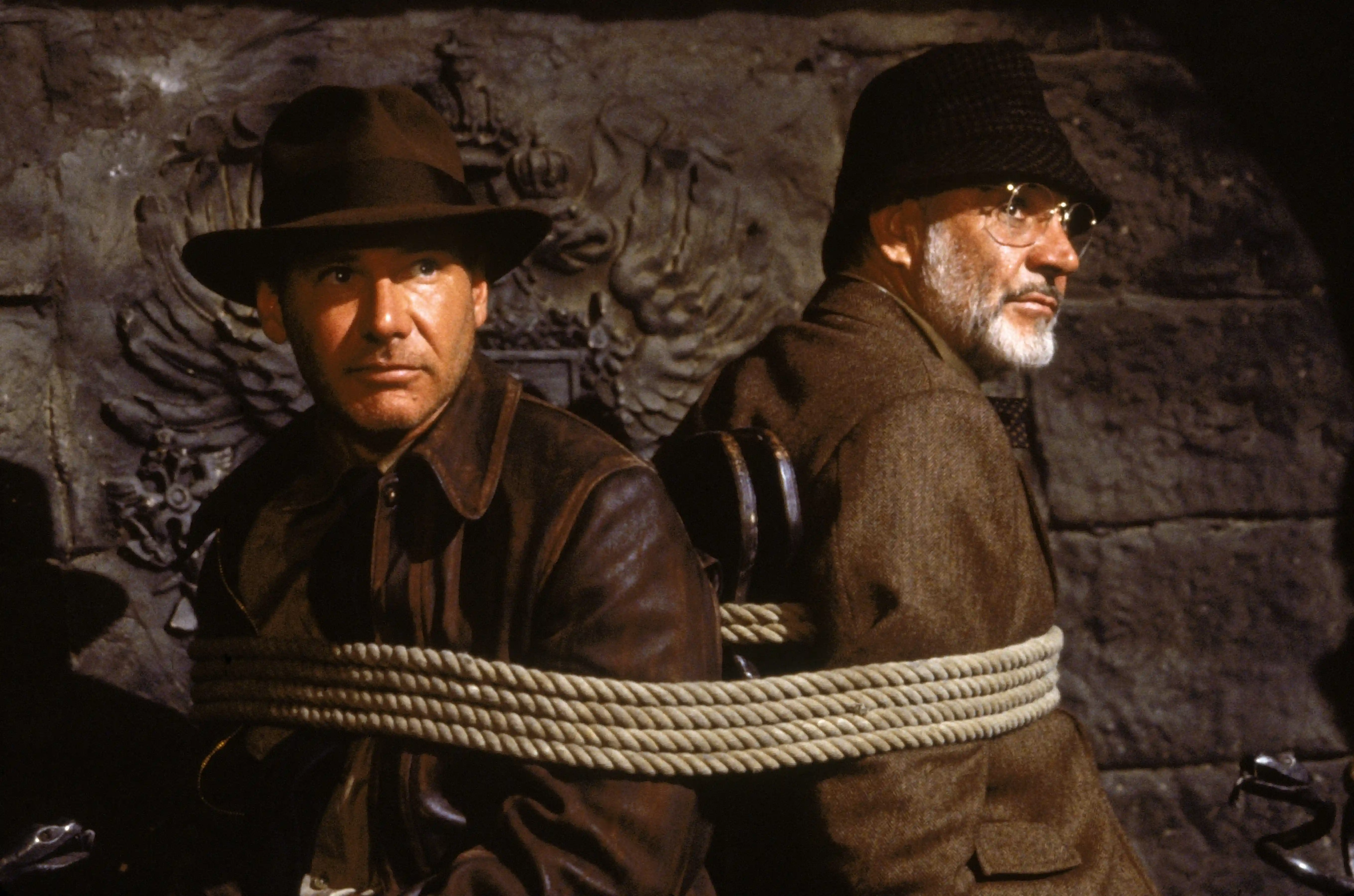 Harrison Ford and Sean Connery sit shoulder-to-shoulder.