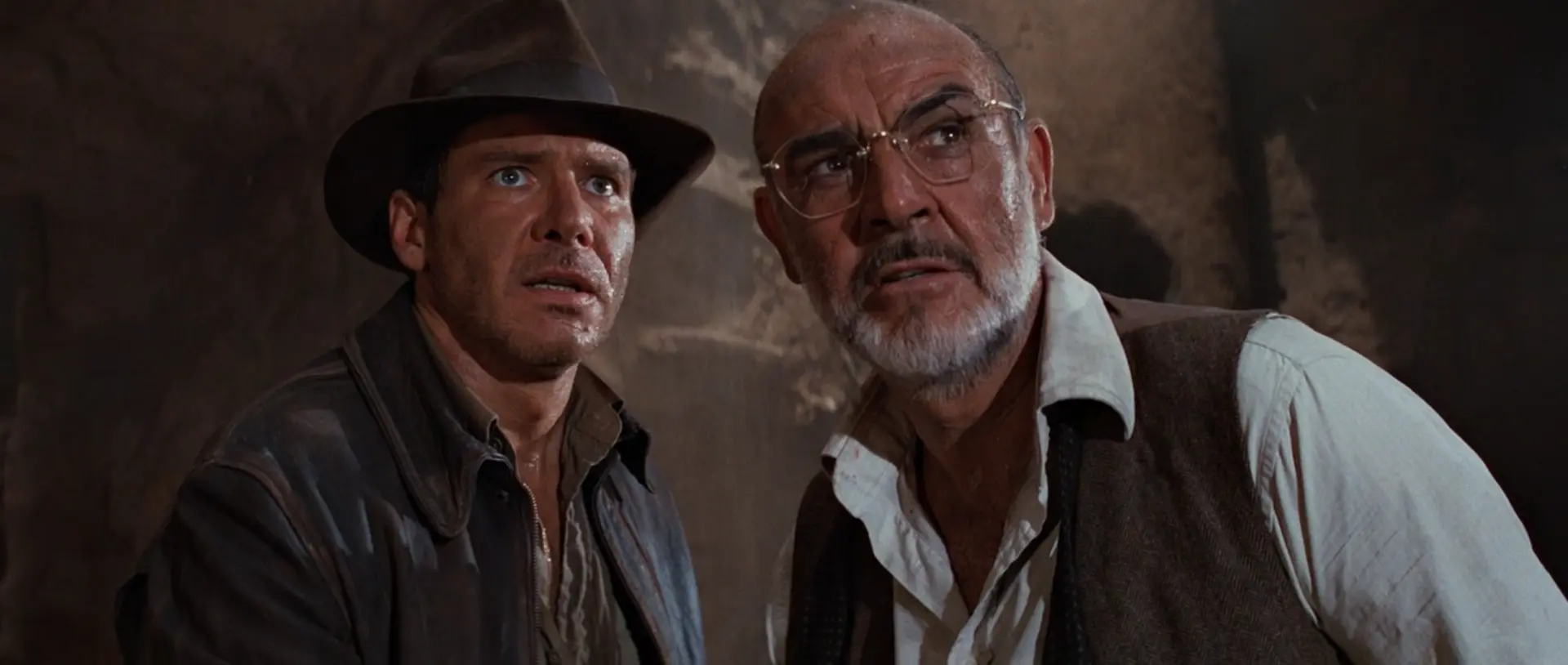 Indiana Jones (Harrison Ford) and his father (Sean Connery) observe a Knight.