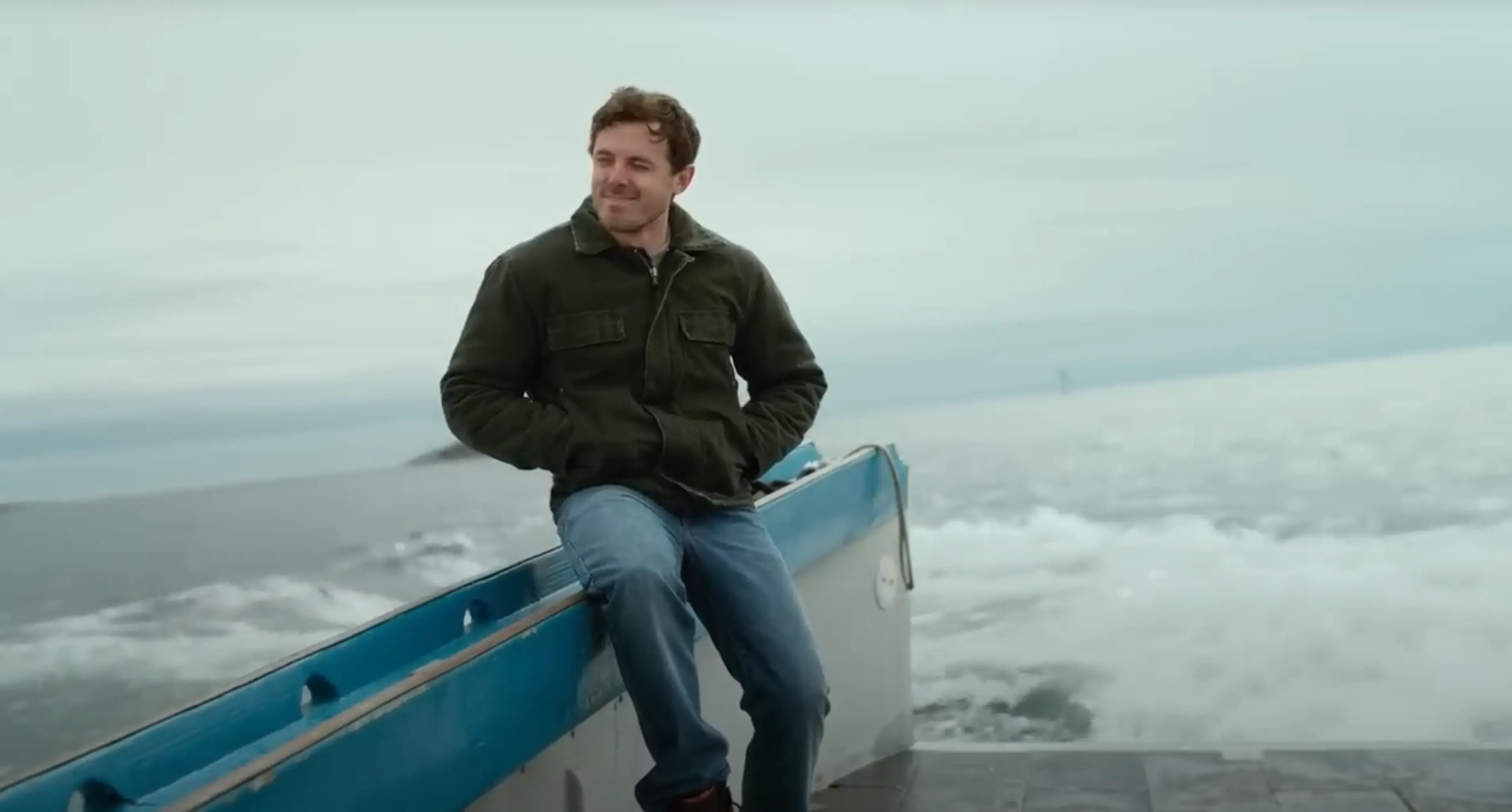 Lee (Casey Affleck) smiles for the first time on his boat.