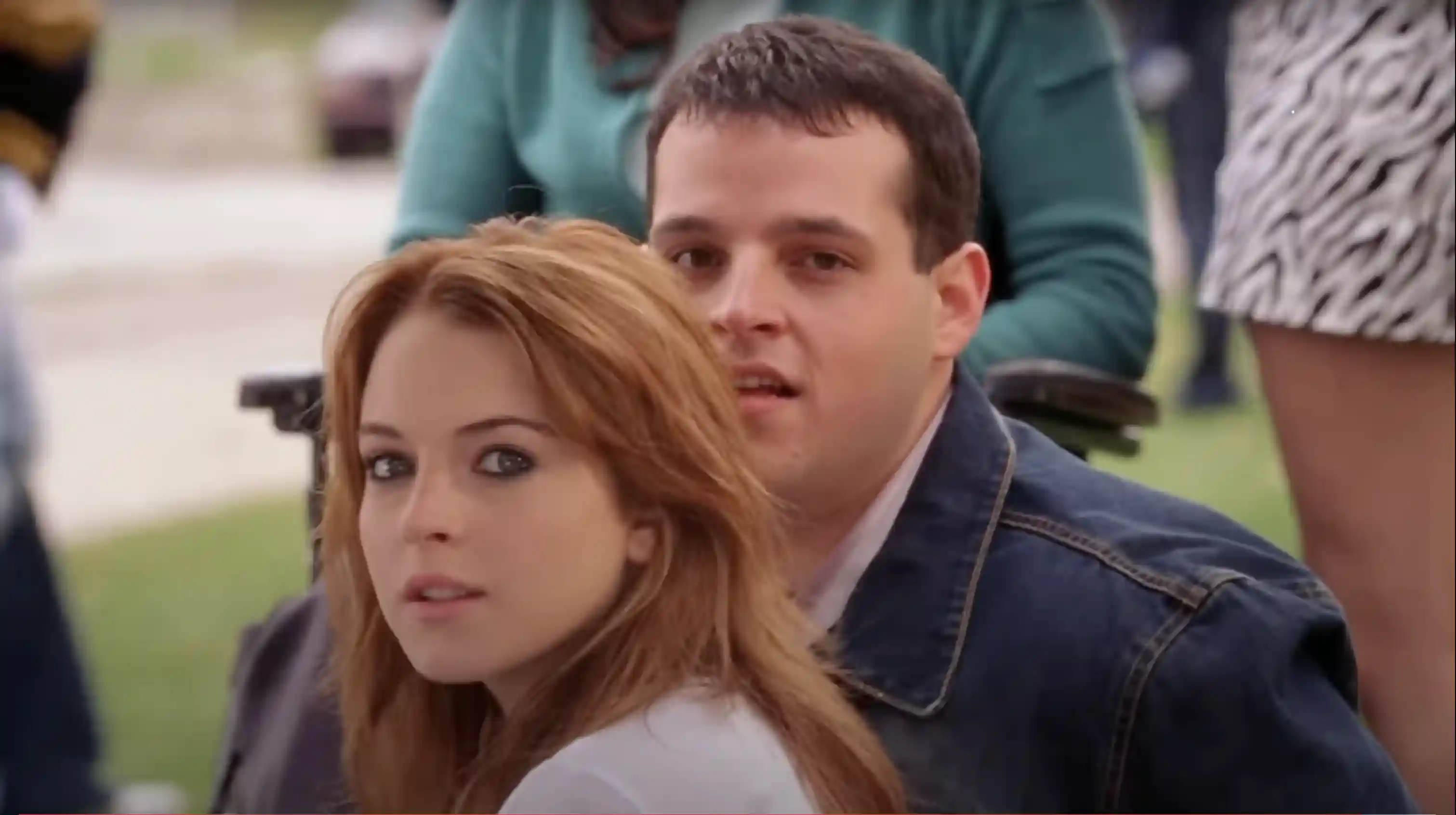 Cady Heron (Lindsay Lohan) and Damien (Daniel Franzese) gaze at the new Plastics arriving at school.