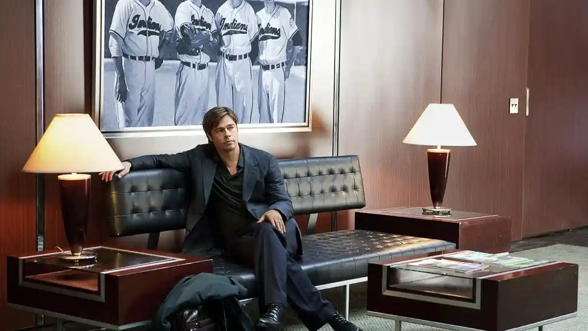 Billy Beane sits in a plush waiting room, daydreaming about the past.