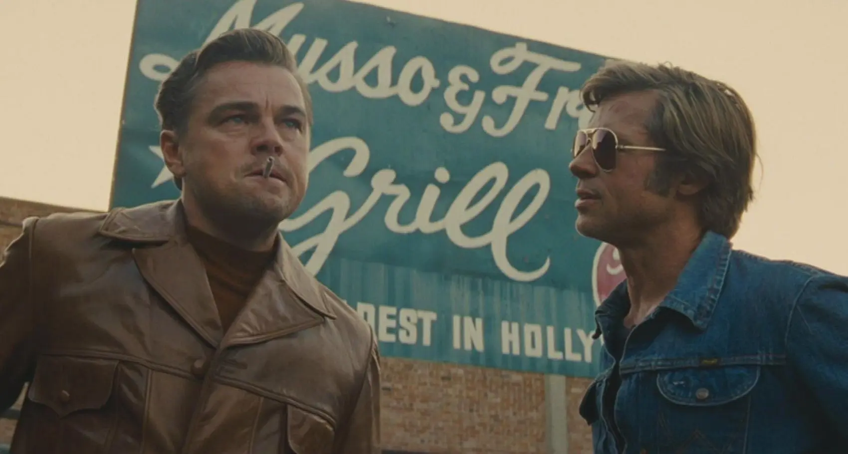 Leonardo DiCaprio and Brad Pitt play a fictional actor and stunt double, respectively.