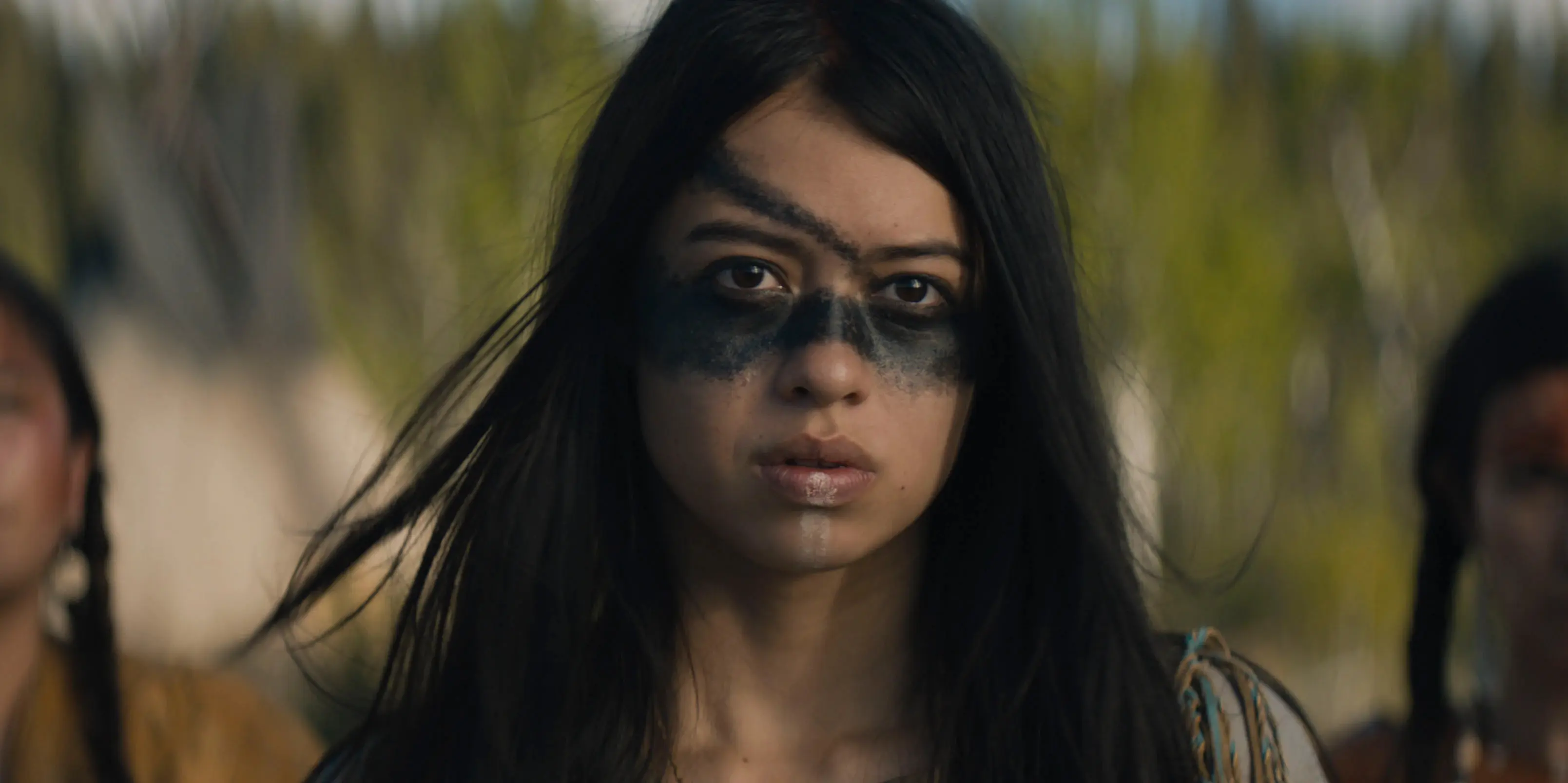 Naru (Amber Midthunder), a Comanche warrior, gazes into the camera.