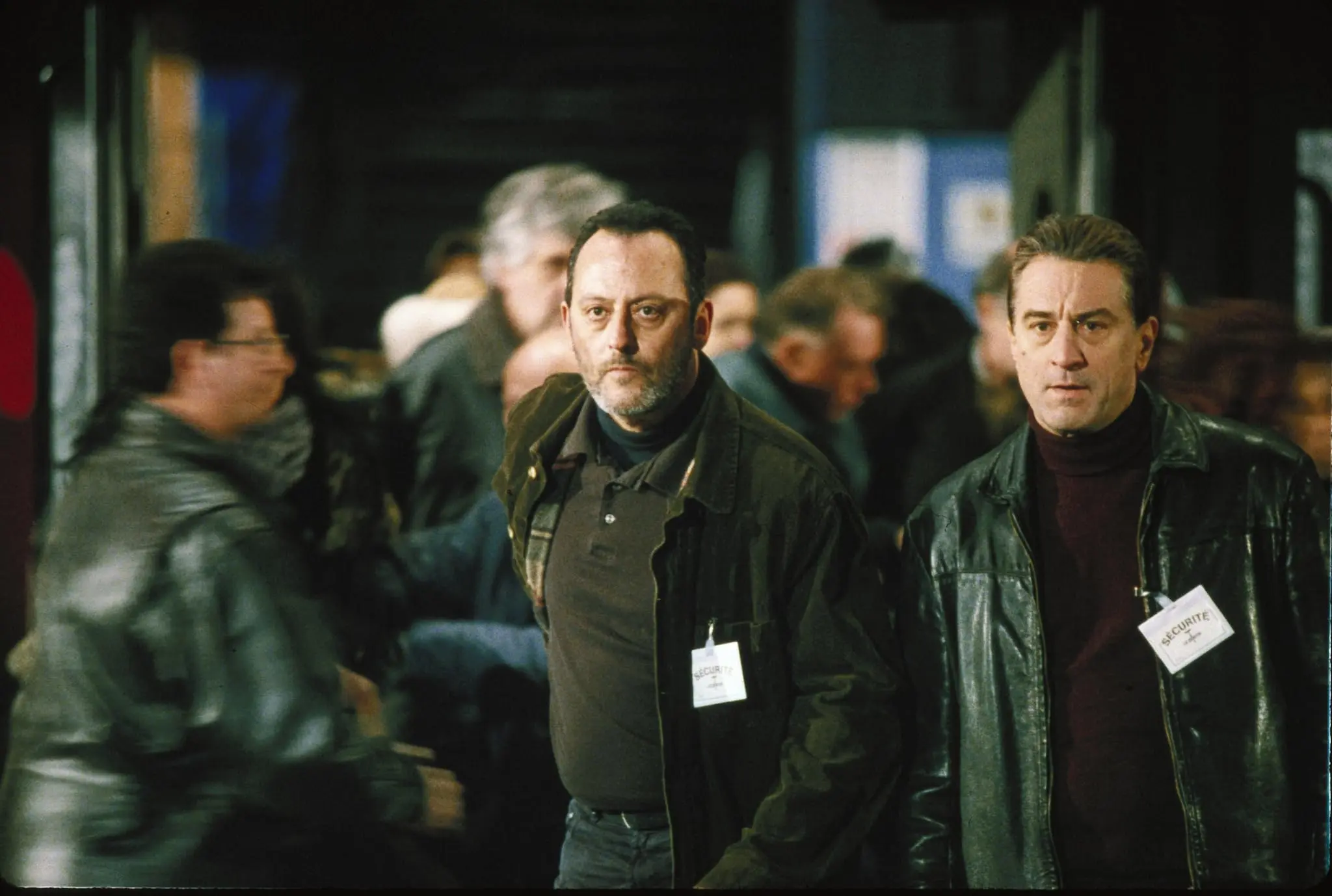 Robert De Niro and Jean Reno play two spies, chasing a target in a crowd.