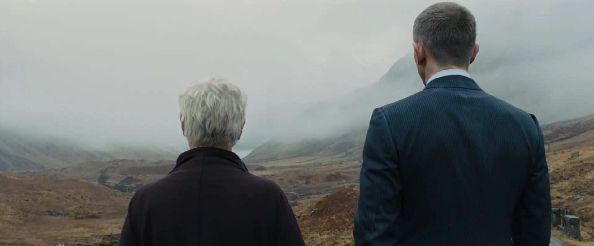 James Bond (Daniel Craig) and M (Dame Judi Dench) observing the Scottish countryside.