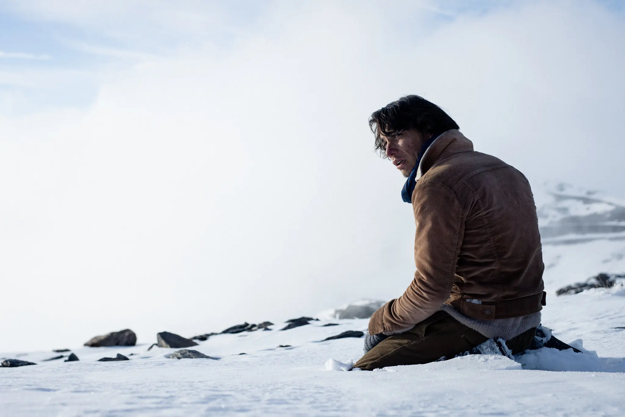 Numa (Enzo Vogrincic), a survivor of a plane wreck in the Andes Mountains, stares in distress.