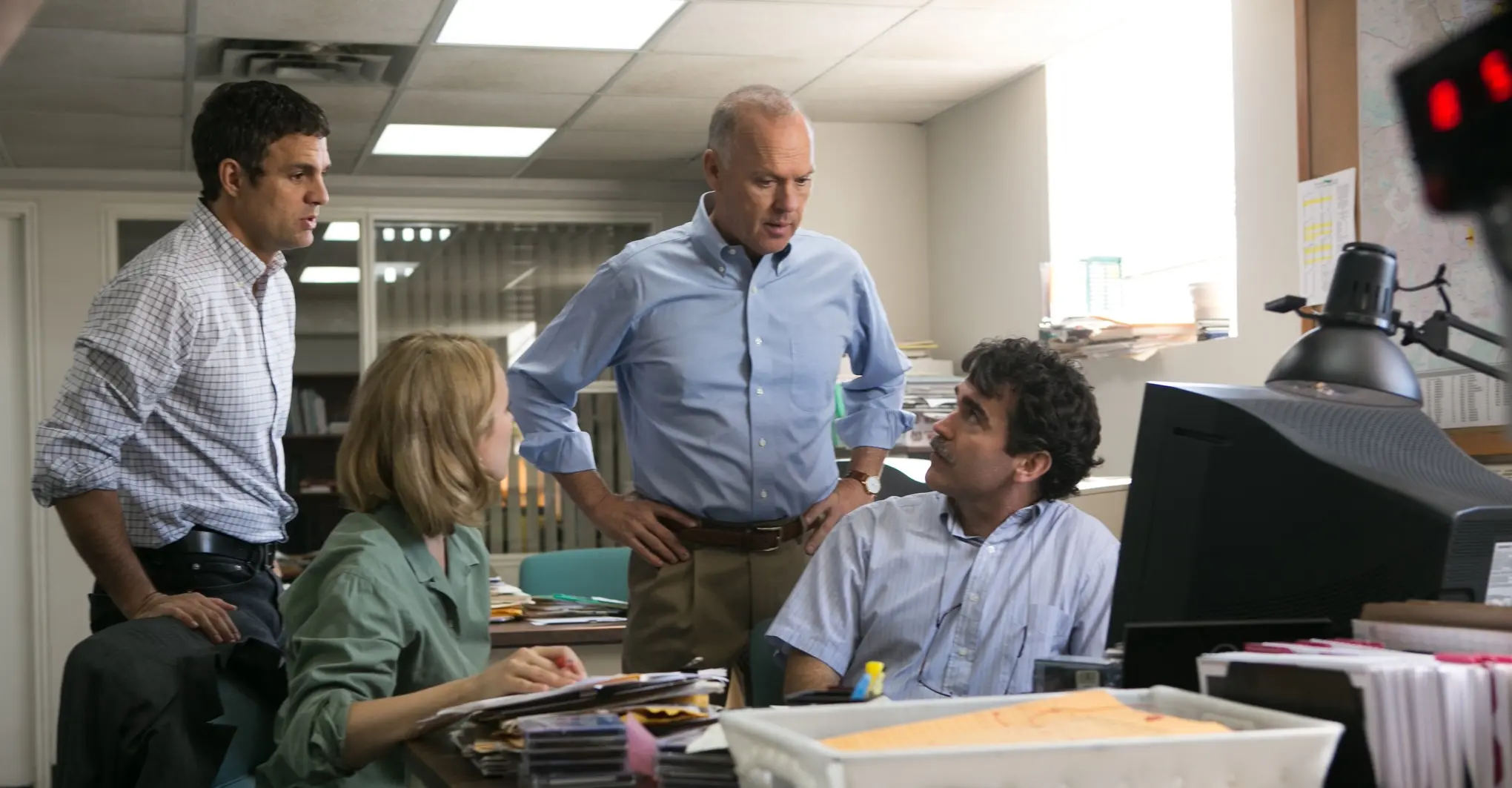 A team of journalists expresses astonishment over the data on their computer.