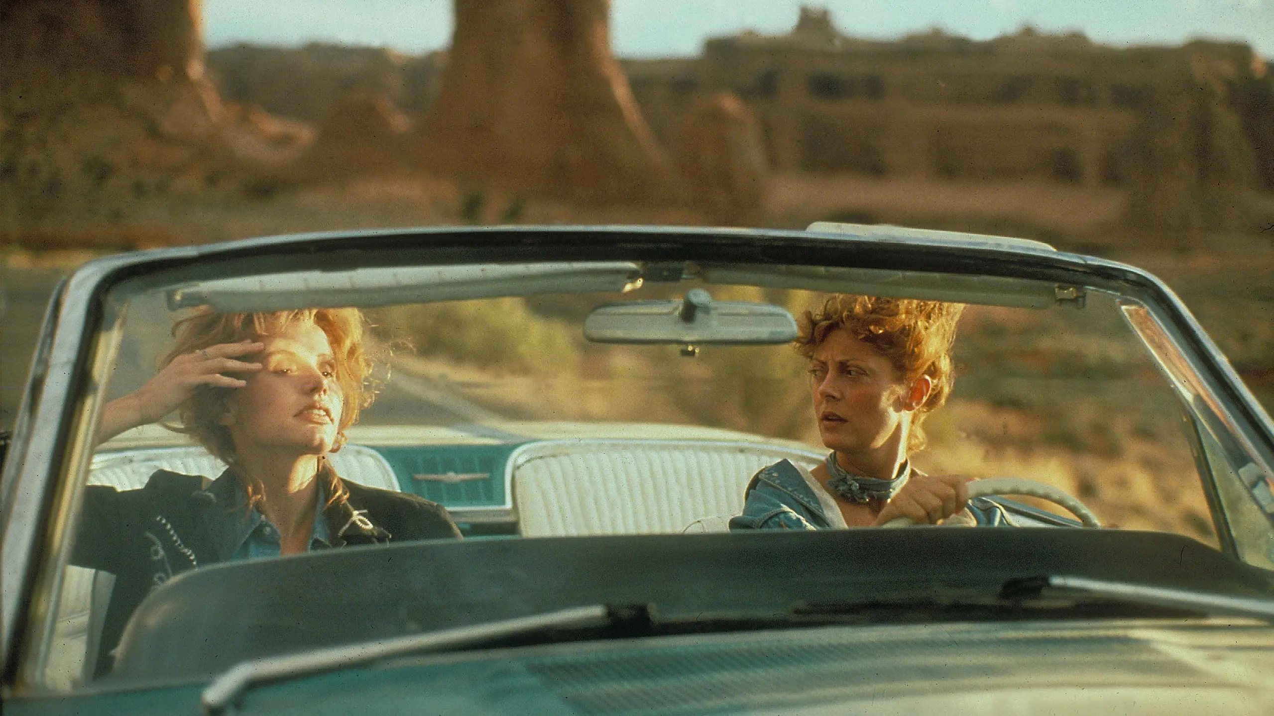 Thelma and Louise drive together in Monument Valley.